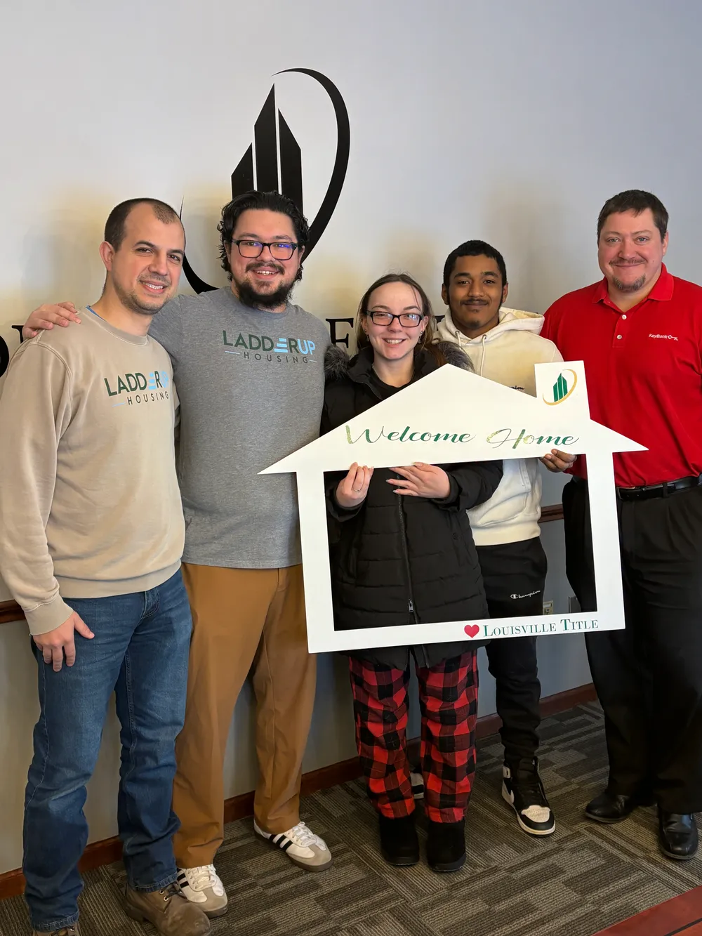 Charaty and Francisco celebrate becoming new homeowners with the LadderUp Housing team in Toledo, Ohio